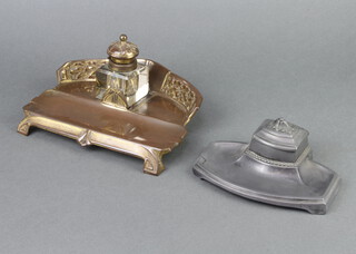 An Art Nouveau embossed gilt metal and glass standish, fitted an inkwell, raised on panelled supports 10cm x 21cm x 16cm together with a pewter ditto complete with ceramic inkwell 5cm x 15cm x 11cm 
