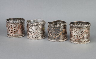 A set of 4 silver plated pierced repousse bottle holders 9cm 