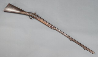A 19th Century muzzle loading percussion fowling piece with 89cm barrel with proof mark, walnut stock with chequer carving 