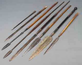 An African double sided leaf shaped spear on a turned wooden shaft 135cm l x 10cm 2, 5 spears with wooden shafts and 2 steel spear heads