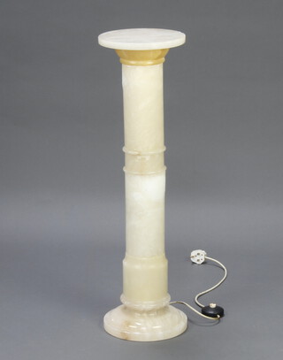 An alabaster turned column lamp raised on a circular base 87cm x 25cm 