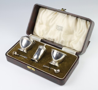 A silver 3 piece Arts and Crafts style condiment Birmingham 1940 together with 2 spoons, 138gms 