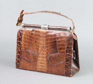A lady's Art Deco crocodile handbag incorporating pockets to the sides 18cm h x 24cm w x 8cm d 
