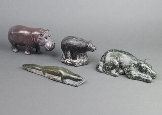 A carved Inuit figure of an otter 3cm x 20cm x 4cm, 1 other of a seated bear 7cm x 18cm x 5cm, 1 other walking hippo 8cm x 15cm x 5cm, together with a Canadian carved figure of a bear 7cm x 10cm x 4cm  
