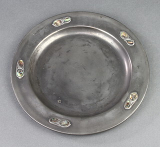 A circular Tudric plate, the edge decorated abalone shells, the reverse marked Tudric 1018 23cm diam. 