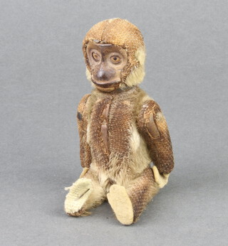 A scent bottle in the form of a monkey with articulated limbs 12cm x 5cm x 2cm 