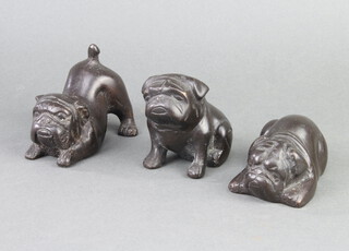 Three bronze figures of pugs, playing, sitting and lying down