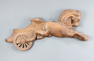 A 20th Century carved pine plaque in the form of a horse and chariot 26m h x 74cm w x 5 cm d 