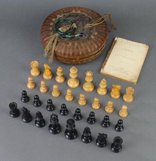 A Staunton carved wooden chess set contained in a Chinese wicker basket  