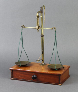 A pair of brass gold scales raised on a rectangular wooden base 34cm x 26cm x 13cm 