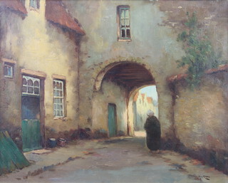 20th Century oil on canvas, indistinctly signed, figure in a Continental townscape 39cm x 49cm 