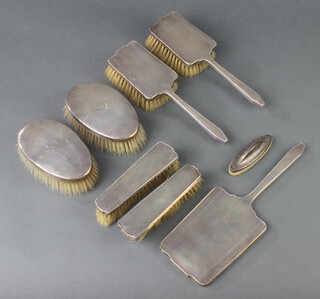 An Art Deco style silver backed brush set comprising 2 hair brushes, 2 clothes brushes and a hand mirror, Birmingham 1948 together with other hair brushes and a buffer