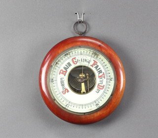An aneroid barometer with porcelain dial contained in a mahogany case 5cm x 21cm 