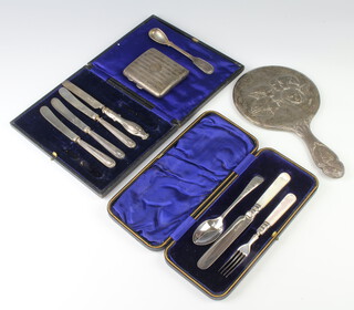 A silver engine turned cigarette case with vacant cartouche Chester 1921, together with a mustard spoon, 124gms gross together with a silver backed hand mirror and 2 cased plated sets 