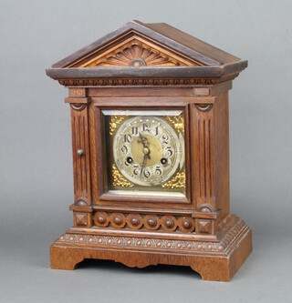 Jerome, an Edwardian 8 day striking bracket clock with 13cm gilt dial, silvered chapter ring and Arabic numerals contained in a carved oak Portico style case 39cm x 29cm x 17cm, complete with pendulum and key  