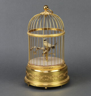 A Swiss Victorian style singing bird automaton contained in a gilt case, the base marked Reuge Music Sainte-Croix Made in Switzerland 29cm x 16cm 
