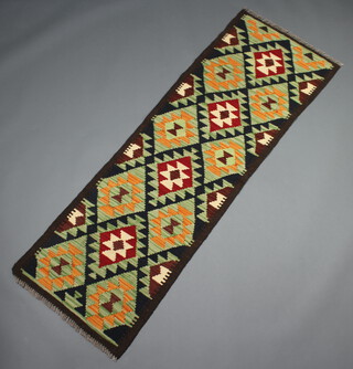 A black, green and tan ground Maimana kilim runner with all over diamond design 190cm x 63cm