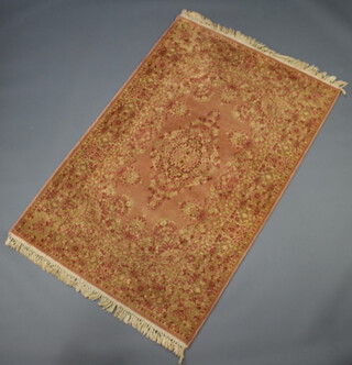 A pink and gold ground machine made Persian style rug 182cm x 122cm 