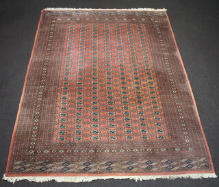 A peach and black ground Bokhara carpet with 189 octagons to the centre within a multi row border 242cm x 257cm 