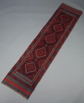A blue and red ground Meshwani runner with 5 diamonds to the centre 250cm x 60cm 