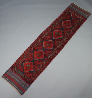 A red and blue ground Meshwani runner with 5 diamonds to the centre 243cm x 56cm 