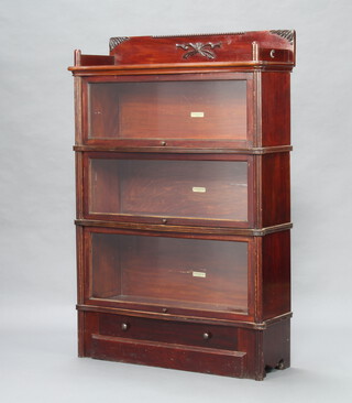 A mahogany Globe Wernicke 3 tier bookcase with raised three quarter gallery enclosed by glass panelled doors above a drawer 137cm h x 90cm w x 31cm d 
