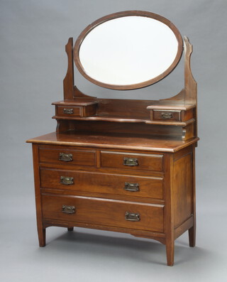 An Edwardian Art Nouveau mahogany dressing chest with oval bevelled plate wall mirror, the base fitted 2 glove drawers above recess, 2 short and 2 long drawers with metal plate drop handles 159cm h x 106cm w x 46cm d 