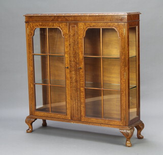A Queen Anne style figured walnut display cabinet with adjustable shelves enclosed by arched astragal glazed panelled doors, raised on cabriole supports 114cm h x 106cm w x 30cm d  