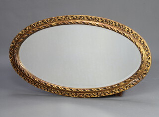 An oval bevelled plate wall mirror contained in a decorative pierced gilt frame 102cm h x 59cm w 