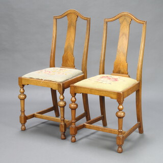 A pair of 1930's Queen Anne style walnut slat back bedroom chairs, the seats upholstered in Berlin woolwork, raised on turned supports with H framed stretchers 92cm h x 43cm w x 41cm d (seat 20cm x 21cm), marked to the underside C.B  