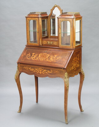 A 19th Century French inlaid rosewood bonheur du jour, the raised superstructure fitted an arch shaped bevelled plate mirror above a drawer flanked by cupboards enclosed by glazed panelled doors, the fall front revealing 3 pigeon holes, drawers and a well, raised on cabriole supports with gilt metal mounts throughout 158cm h x 82cm w x 54cm d