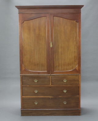 An Edwardian mahogany linen press with moulded and dentil cornice, the interior fitted 3 trays enclosed by panelled doors, the base fitted 2 short and 2 long drawers, raised on bracket feet 216cm h x 130cm w x 62cm d 