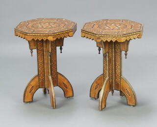 A pair of Moorish octagonal inlaid olive wood and mother of pearl pedestal tables, raised on panelled supports 55cm h x 39cm w x 39cm d, complete with plate glass tops 