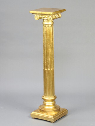 A gilt painted fluted column with Ionic capital, raised on a square base 111cm h x 27cm x 28cm 