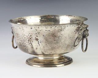 An Edwardian hammered pattern silver pedestal bowl with lion ring drop handles, London 1908, 456 grams 17.5cm
