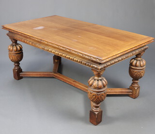 A 17th Century style carved oak draw leaf dining table raised on cup and cover supports with Y shaped stretcher 76cm h x 91cm w x 167cm l x 331cm l when extended   