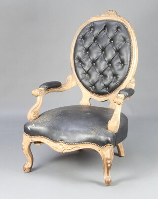 A Victorian carved bleached mahogany open armchair, the back and seat upholstered in black leather material, raised on cabriole supports 100cm h x 61cm w x 57cm d   