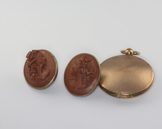 A pair of Victorian carved lava studs decorated with portrait of ladies together with a gilt locket 