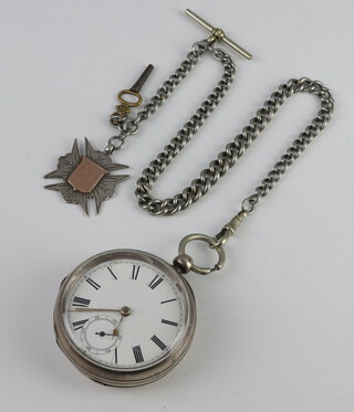 A Victorian silver key wind pocket watch with seconds at 6 o'clock on a plated Albert with silver fob and key 