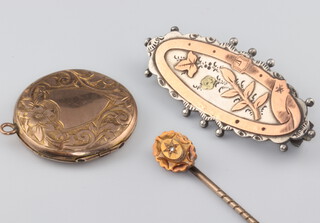 An Edwardian gold tie pin, a silver brooch and gilt locket 