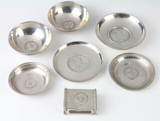 A white metal coin set dish 9cm, 5 others and a match sleeve holder, gross weight 296 grams