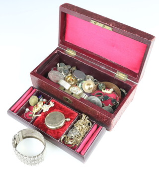 An Edwardian silver bangle, minor vintage and other costume jewellery contained in a red leather trinket box 