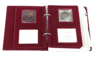 An Augustus bronze coin, 3 others in a velvet folder