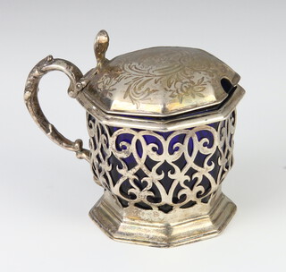 A Victorian pierced silver octagonal mustard with scroll decoration and blue glass liner, London 1854, 126 grams, 8cm 
