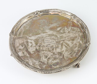 A George III silver card tray with beaded rim on claw and ball feet, London 1775, 18cm, 244 grams, with later presentation inscription, 17cm 