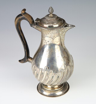 A Victorian silver baluster hot water jug with spiral decoration and engraved inscription and armorial, London 1892, gross weight 434 grams, 23 cm