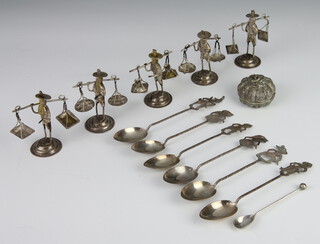 Five repousse white metal figures of street traders, 7 spoons and a palm box 