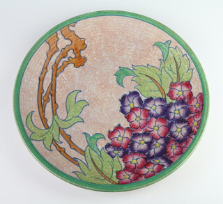 A Charlotte Rhead platter decorated with stylised flowers, signature mark to the base 32cm