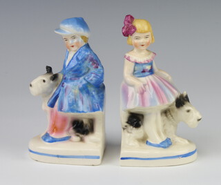 A pair of Goebels style Art Deco bookends in the form of a boy and girl with dogs no.3590 14cm 