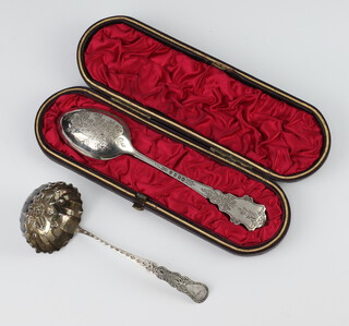 A Victorian silver spoon Birmingham 1884 with engraved decoration cased, together with a sifter spoon 46 grams